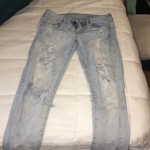 American Eagle Light-washed skinny jeans w/ holes